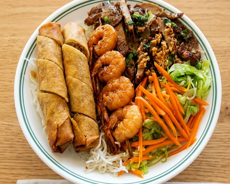Lemongrass beef vermicelli bowl with spring rolls and charbroiled shrimp at Ha Long Bay, downtown Calgary