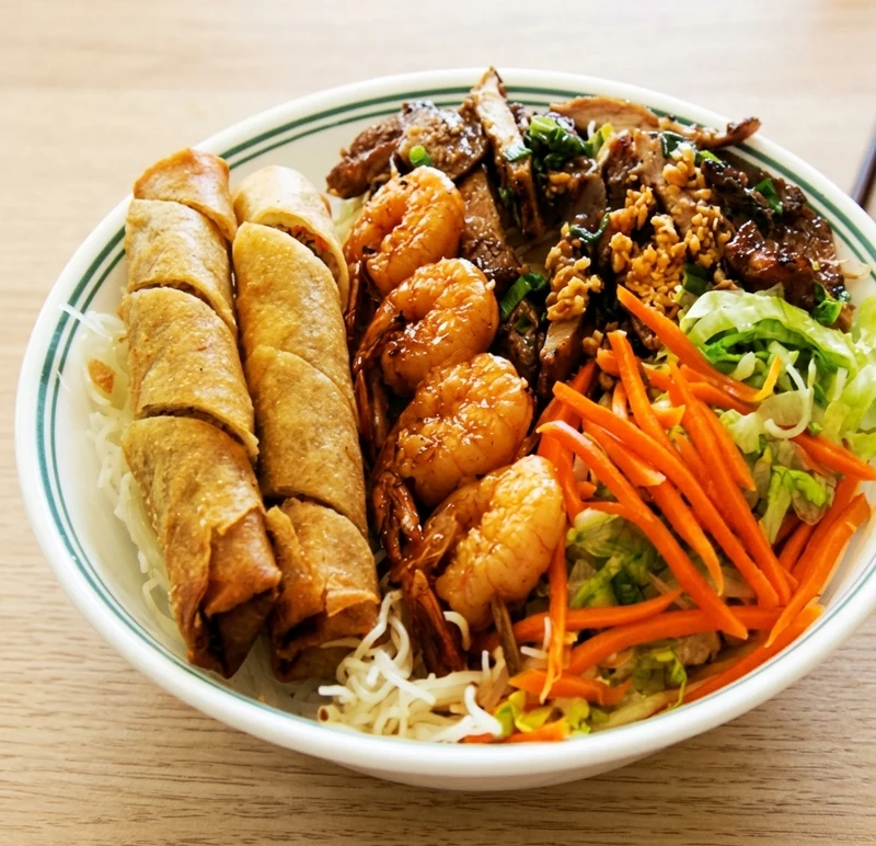 Vermicelli with lemongrass beef, spring rolls and charbroiled shrimp in Calgary